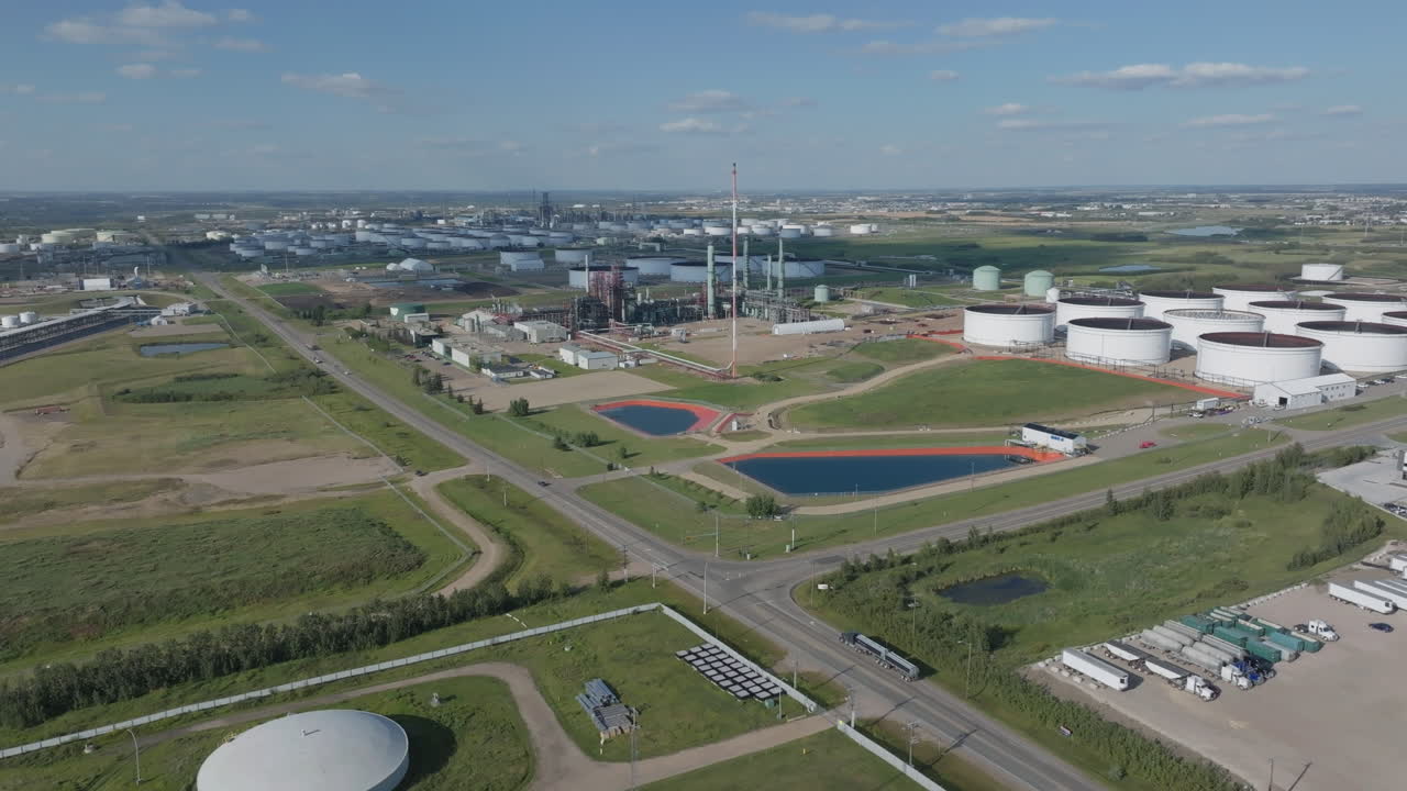 Aerial view over large oil refinery on clear day with blue sky