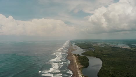 aerial view of ocean waves in the beach along the rio acome and sipacate-naranjo national park in el paredon, guatemala