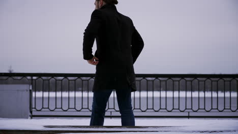 Man-standing-up-and-walking-outdoors