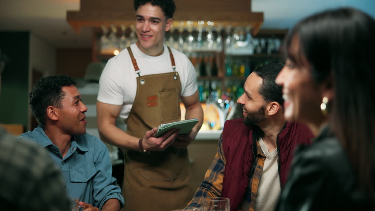 Waiter serving customers in a restaurant