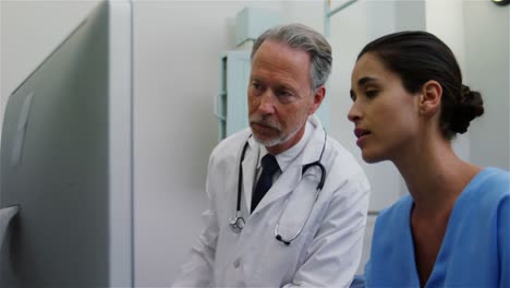 surgeon and colleague discussing computer