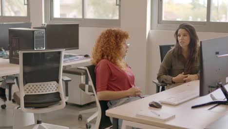 coworkers talking relaxed in the office during a work break
