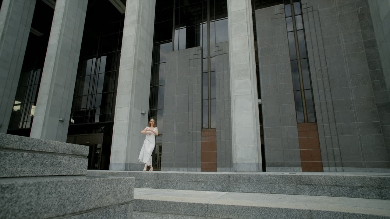 Ballet dancer performing in front of a building