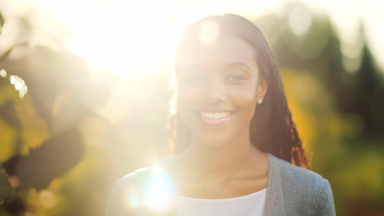 Portrait of a young woman smiling outdoors