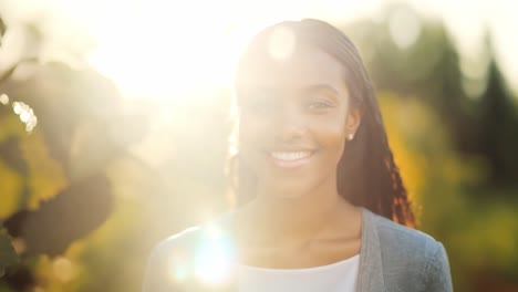 portrait of a young woman smiling outdoors