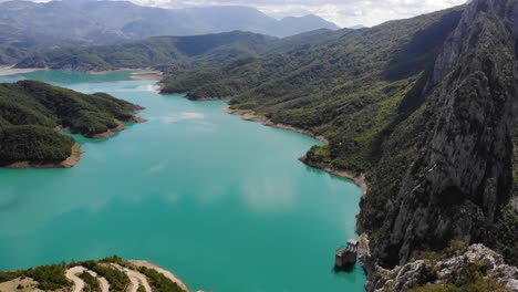 drone fly above young hiker revealing stunning scenic landscape in bovilla lake albania