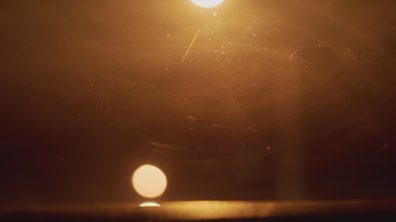 Silent night illuminated by warm streetlight, Softly shining lamp casting gentle glow on urban street, Serene night scene highlighted by warm glowing streetlamp and cinematic effects