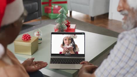 Happy-african-american-senior-couple-on-video-call-with-female-friend-at-christmas
