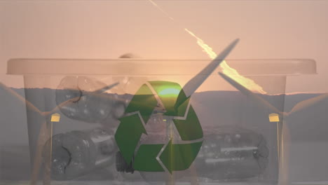 animation of green recycling sign over box with plastic bottles and wind turbines