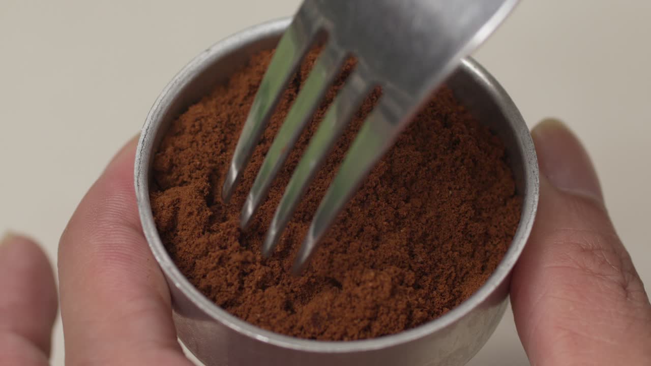 Using a fork to clean up messy coffee grounds