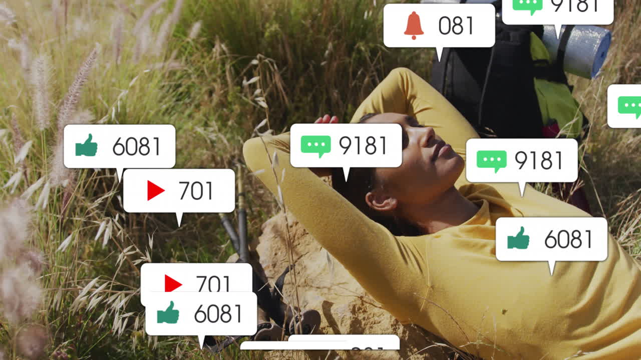 Woman lying on rock in sunlit field, showing floating social media icons for content marketing