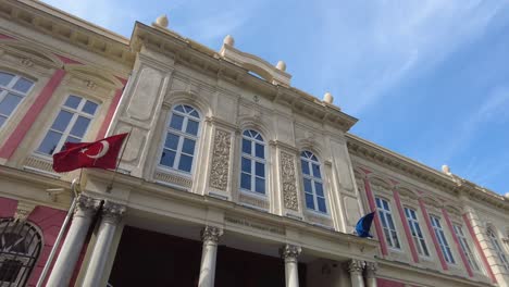 turkish and european union flags on a historic building