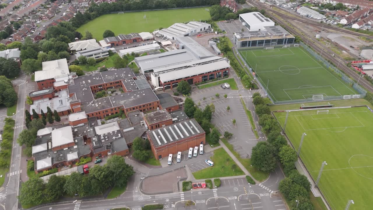 Aerial view of a large educational campus with sports fields and buildings