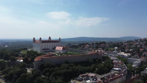 aerial view of bratislava castle and old town during the day, drone aerial view 4k establishing shot of the slovakian european capital city during the summer, stunning view of the landmark