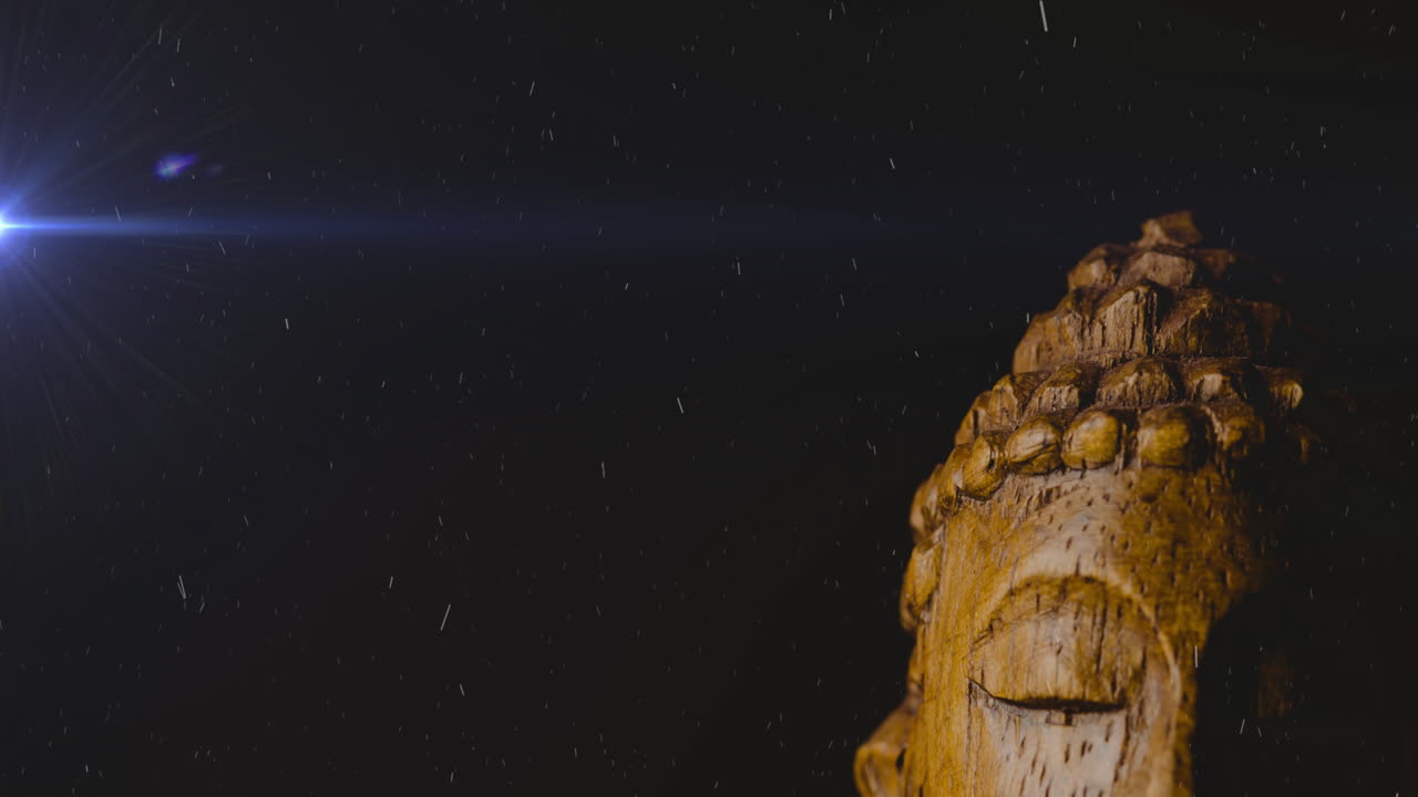 Statue of Buddha in subtle light, partially visible against dark background