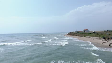 Flight-Over-Ocean-With-Foamy-Waves-In-Vama-Veche,-Romania---drone-shot