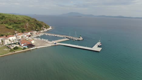 a drone shot of an island village near a sandy beach