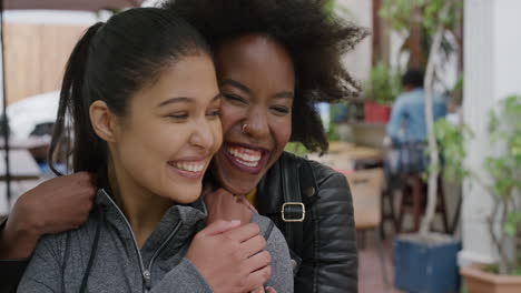 portrait of young woman suprise hugging friend girlfriends embracing laughing enjoying togetherness urban youth friendship hang out