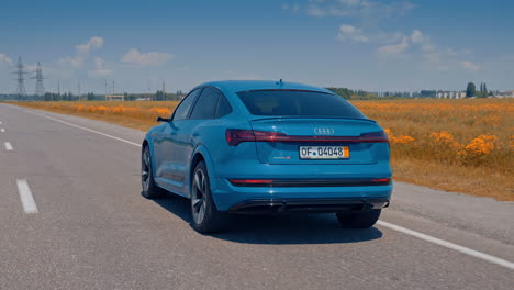 back shot of audi e-tron. shot of the back of audi e tron driving on road