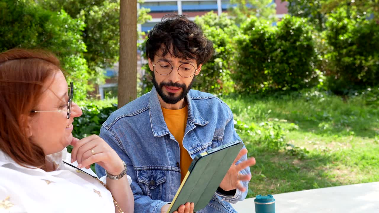 Couple using tablet in the park