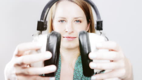 cool female dancer with changing retro headphones to listen to music