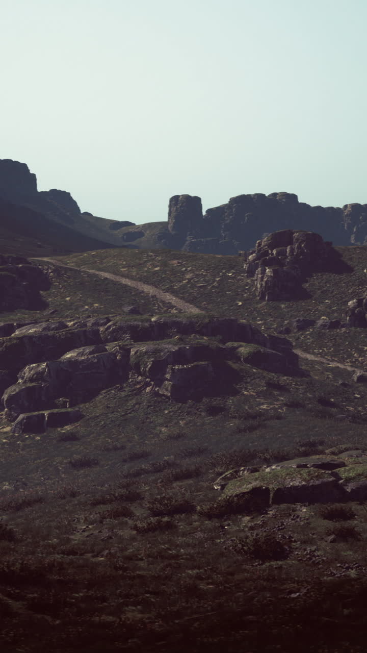 Rocky mountain landscape with winding path amidst rugged terrain