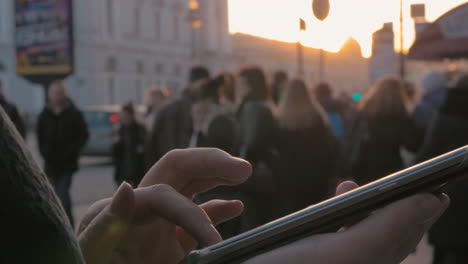 woman using cellphone in the city at sunset