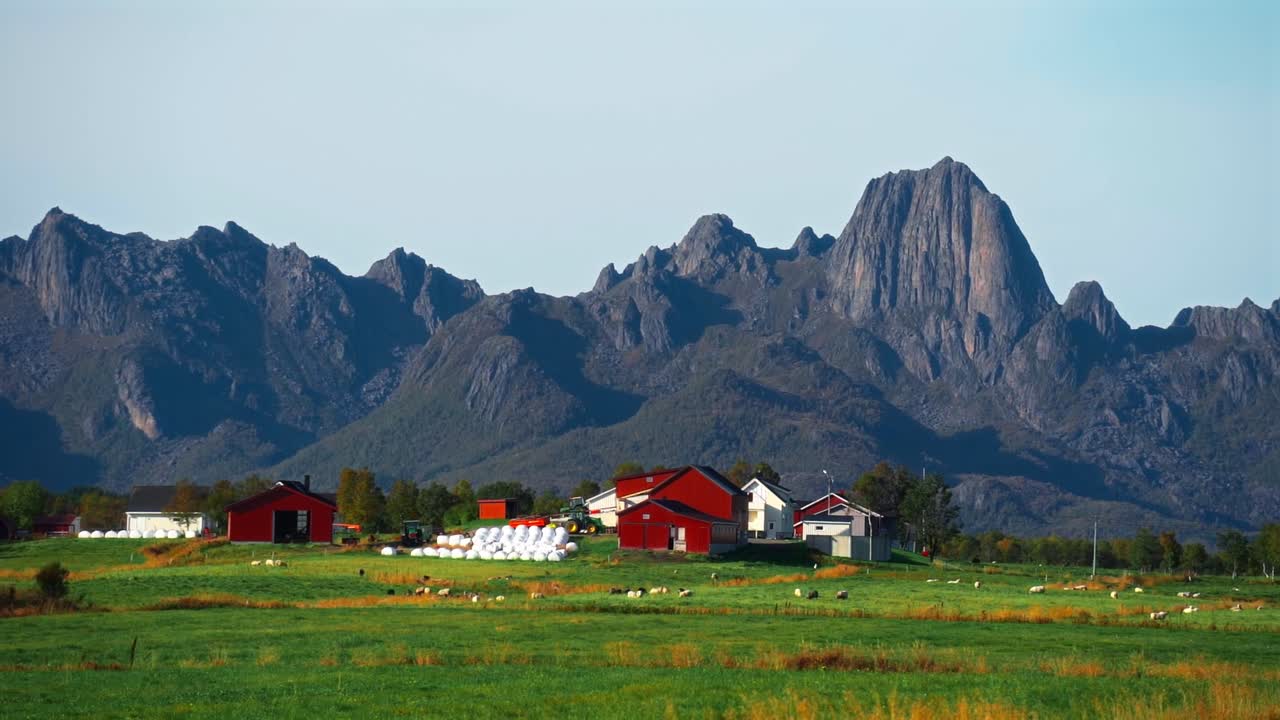 Majestic mountains with lush greenery surrounding a scenic red farm in Vestarelen