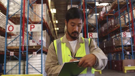 portrait of a young man working in a warehouse smiling 4k