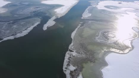 spring ice drift on the frozen winter river lake overflight - drone collection stock video