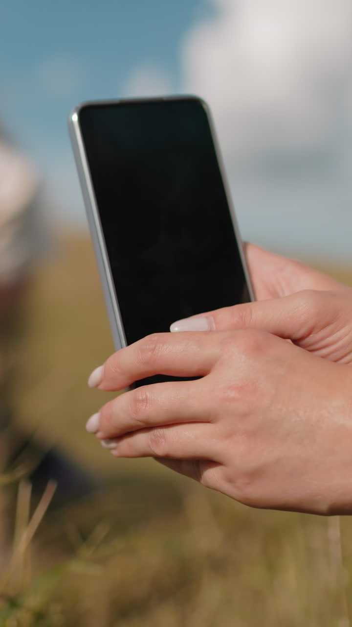 fotógrafo capturando la imagen de un amigo acostado en una bala de heno mientras otra persona camina en un entorno rural soleado, destacando el ocio al aire libre, la amistad y la creatividad en la naturaleza