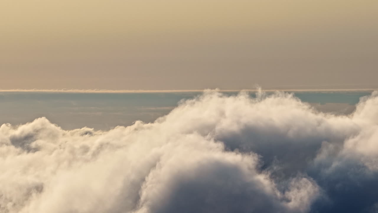 Flowing fluffy clouds and sunset sky, aerial time lapse view