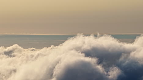 flowing fluffy clouds and sunset sky, aerial time lapse view