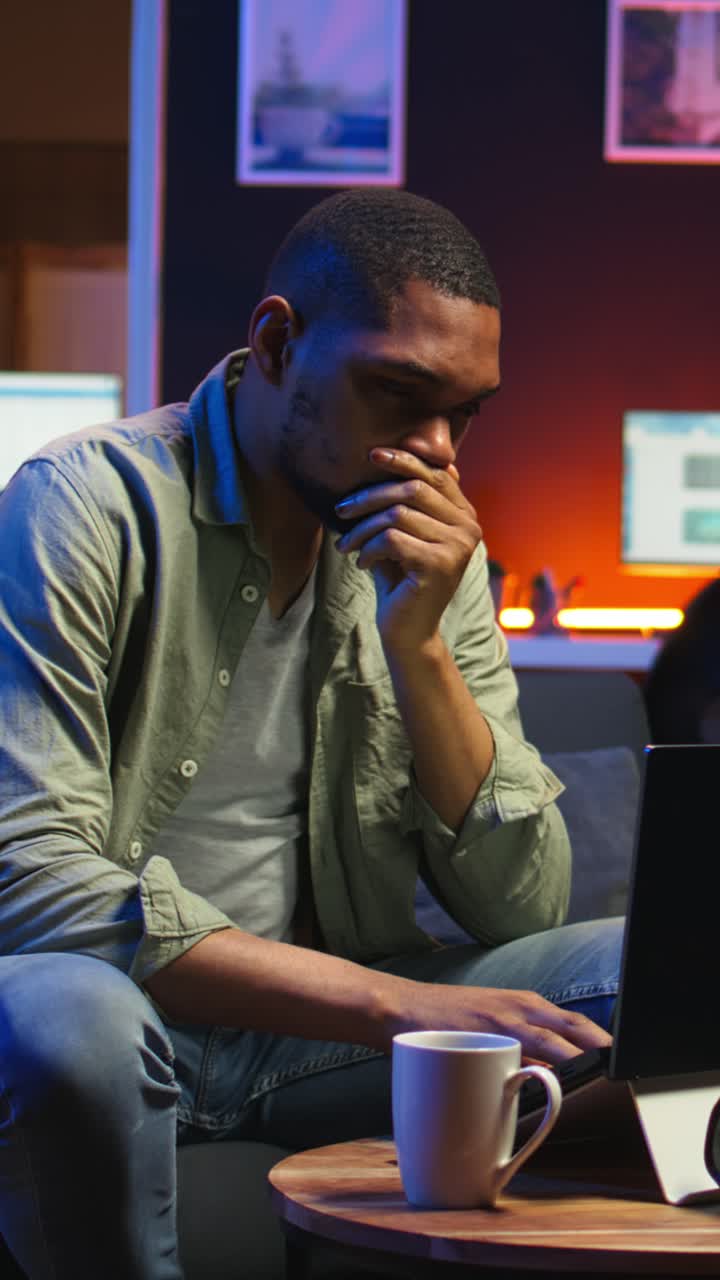 Vertical Video African american guy being overworked with headache at modern loft