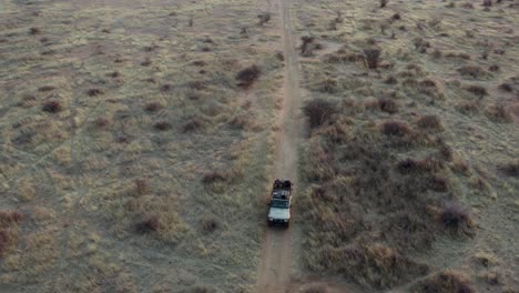 aerial pull back reveal safari jeep and stunning landscape, namibia