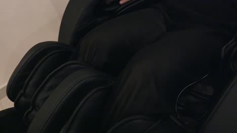 a woman is enjoying relaxation in a comfortable massage chair - close up