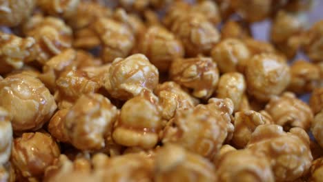 macro detail closeup of fresh hot golden popcorn, handheld