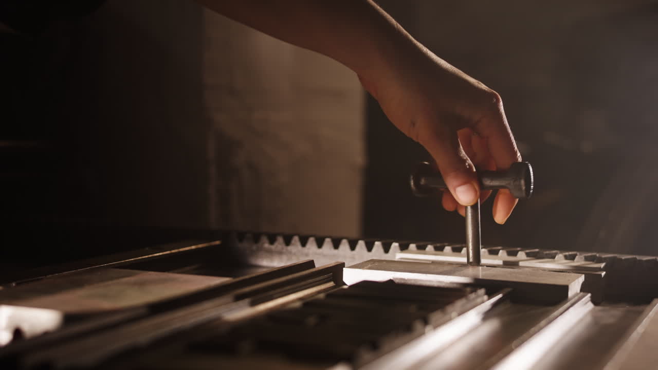 Hand Operating a Vintage Printing Press