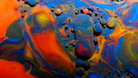 slow motion bright colors bubbles oil beautiful paint universe color moving multicolored close up. acrylic paint. fantastic hypnotic surface. abstract colorful paint metamorphosis structure bubbles