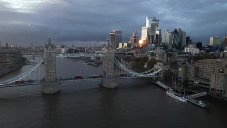 Striking view of Tower Bridge with the modern skyline of the City of London in the background. The iconic bascule bridge spans the river Thames, blending historic engineering with the urban landscape