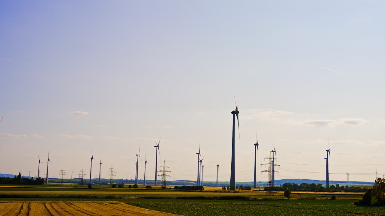 Sunny countryside wind turbines. Wind turbines stand tall in a vast field under a bright sky, showcasing renewable energy in a rural landscape