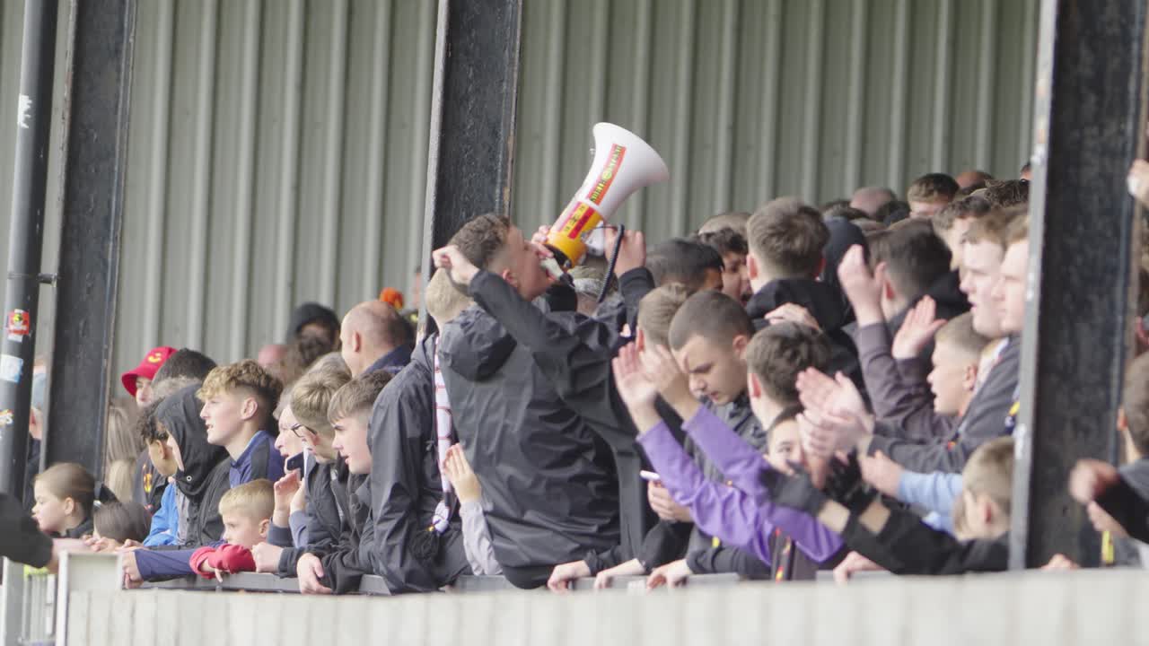 Football rival fans singing, chanting, clapping, soccer arena, Scottish