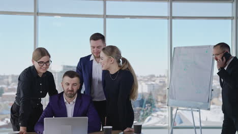 productive and positive working atmosphere in office. team cooperation at problem solving and decision making. male colleague speaks on the phone at backdrop.