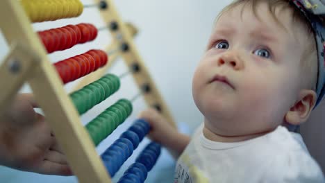 child plays with a multi-colored toy 8