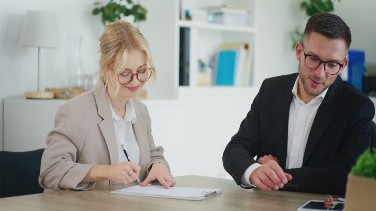 Real Estate Agent Signs Sales Contract with Client