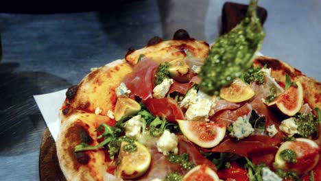 authentic pizza making process in traditional italian pizzeria, with the chef adding topings on the pizza