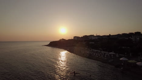 aerial scene of resort and sea at sunset trikorfo beach greece