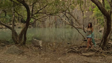 Young-Woman-Walking-Barefoot-On-Exposed-Roots-Of-Tree-At-Cedar-Creek-Falls---National-Park-In-Queensland,-Australia