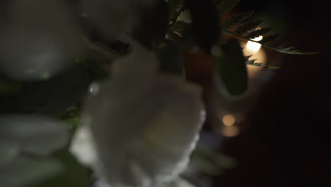 decorative table at wedding event with glowing candles and blurred soft background lights