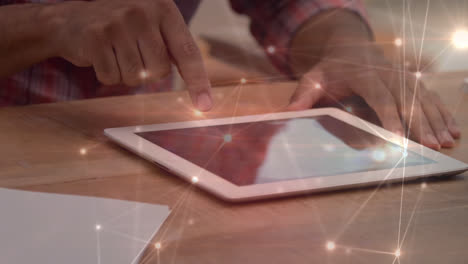 man using a digital tablet with light connections animated on the foreground